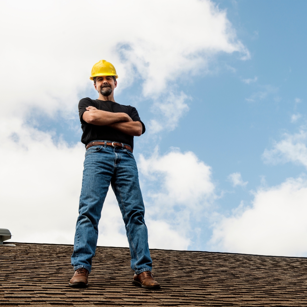 Roofing contractor on top of a house